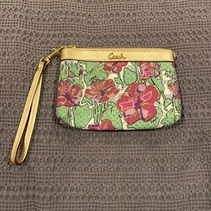 Coach wristlet - floral pattern. Zipper closure and card pouch inside.